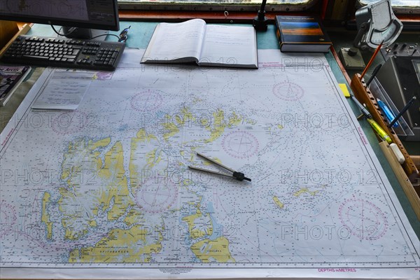 Map and compass on the bridge of the expedition ship