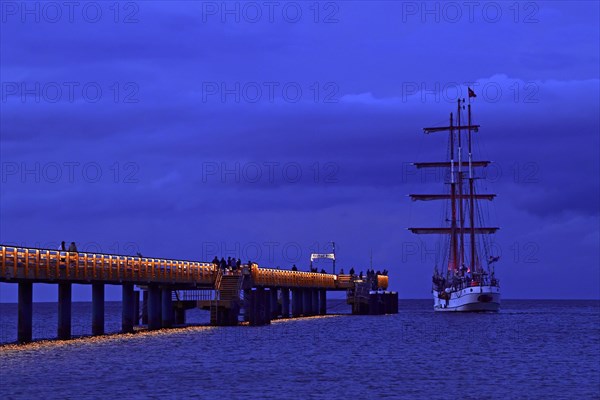 Evening atmosphere jetty with three-master sailing boat