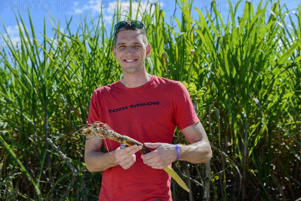 Young man with sugar cane