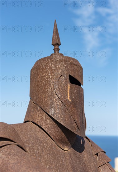 Metal statue of knight in armor