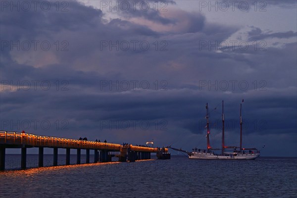 Evening atmosphere jetty with three-master sailing boat