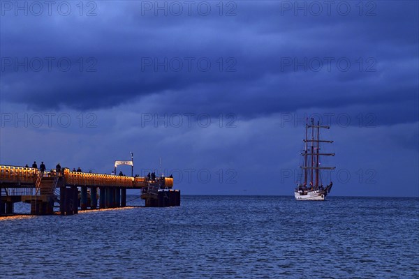 Evening atmosphere jetty with three-master sailing boat