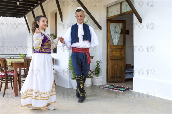 Local folklore group in traditional dress demonstrates national Albanian dance