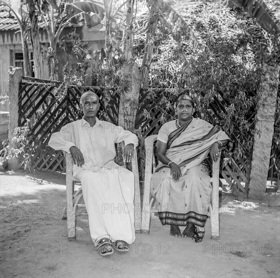 South Asian Indian old man in lungi and women in silk saree