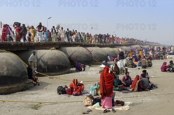 Pilgrims cross the Ganges on a makeshift pontoon bridge