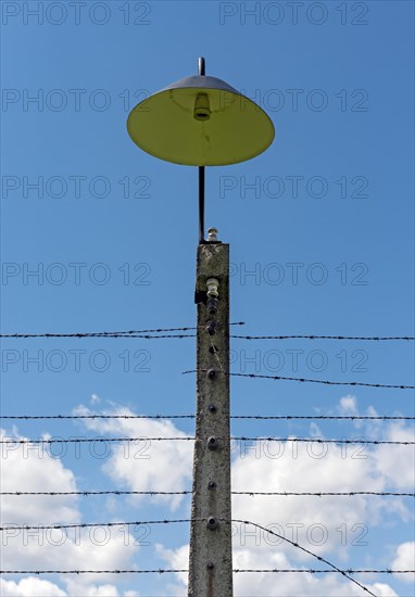 Barbed wire fence and lamppost at Auschwitz II-Birkenau concentration camp