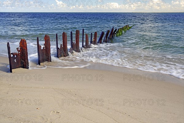 Old steel groynes on the beach at the elbow