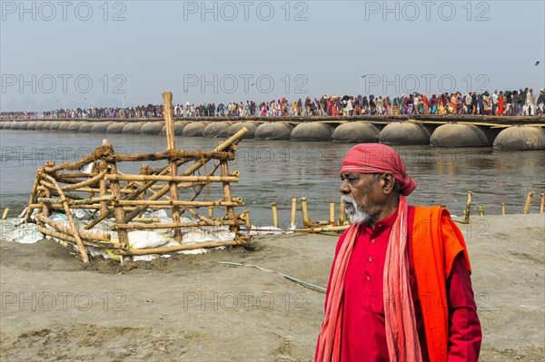 Pilgrims cross the Ganges on a makeshift pontoon bridge