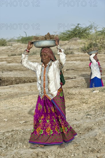 Fakirani woman carrying soil on her head for road work