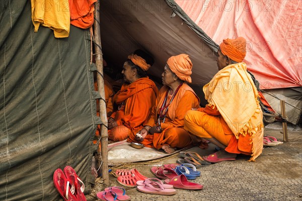 Sadhvi in orange and red saree during Allahabad Kumbh Mela