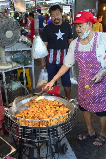 Fish cakes being deep fried