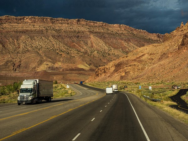 Truck on highway towards Arches Scenic Drive and Arches National Park