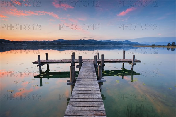 Wooden footbridge on Lake Pfaeffikon at sunrise