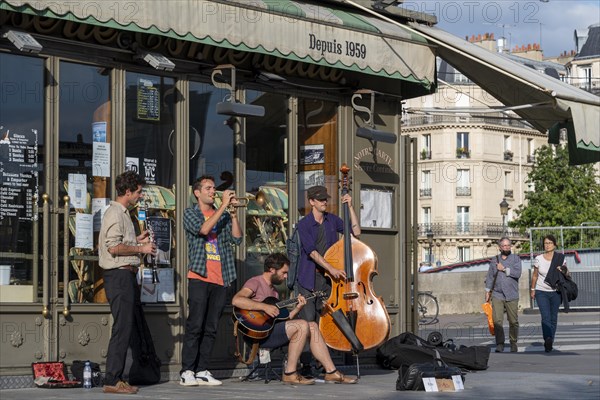 Street musicians play jazz by Louis Armstrong