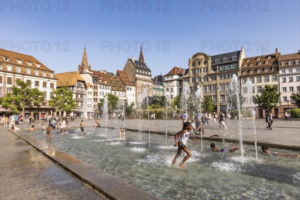 Children playing in a fountain at Place Kleber