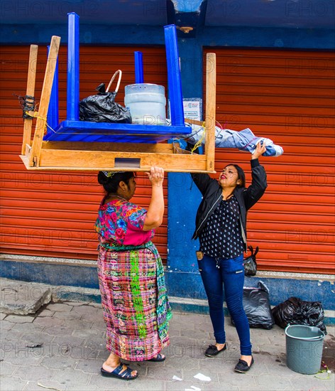 Market woman carrying the entire market stall on her head