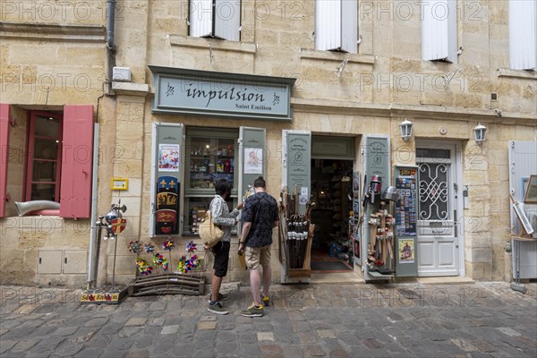 Two tourists in front of a souvenir shop