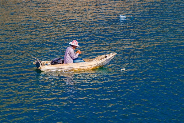 Fisherman in his floating coffin