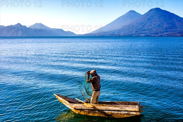 Fisherman with fish trap in his floating coffin