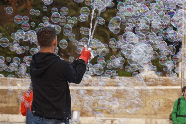Man blowing soap bubbles
