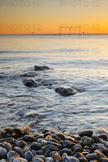 View from Arbon over Lake Constance at sunrise with stones in the foreground