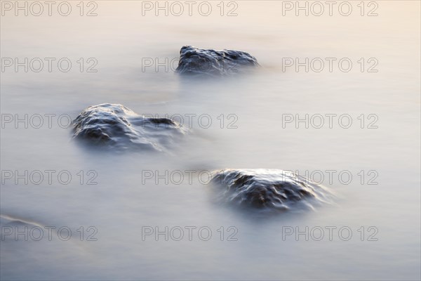 Stones in water photographed with slow shutter speed