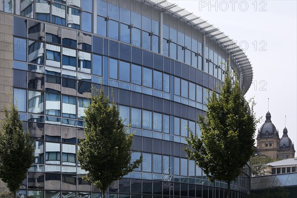 Savings bank tower reflected in the glass facade of GESCO AG