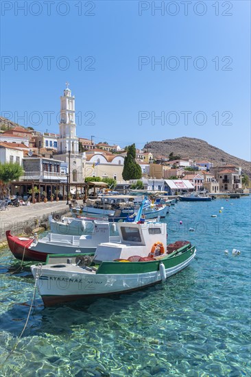 Fishing boats in the harbour of Halki with turquoise water