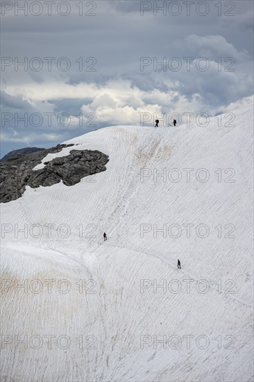 Hiker on old snow field