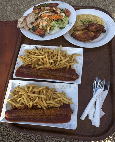 Currywurst with fries on a tray