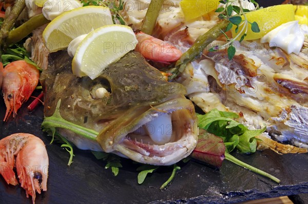 Fish garnished with crabs and lemons