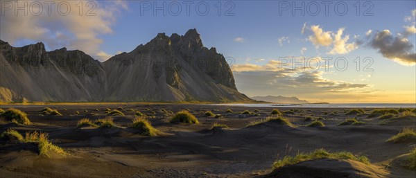 Dune landscape in front of mountain range in the morning light