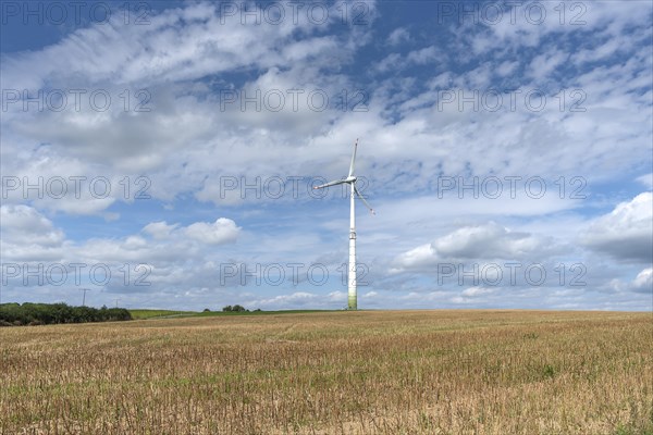 Windmill and cloudy sky