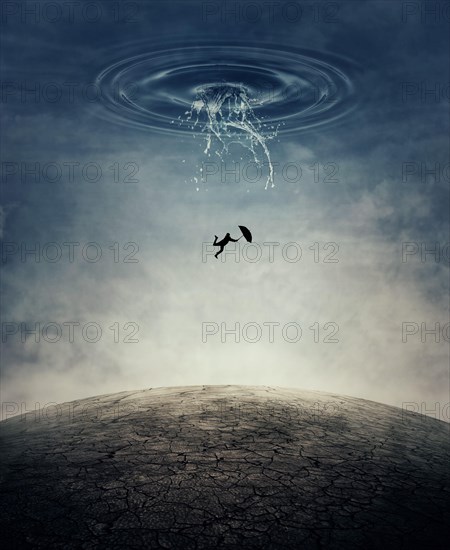 A silhouette of an young man with an umbrella falling from the sky as a splash of water crashing down to the cracked desert ground. Business risk