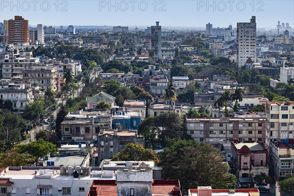 View over sea of houses with lots of greenery of the capital Havana