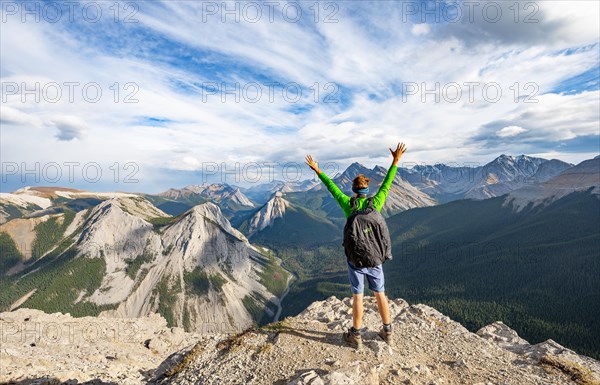 Hiker stretches his arms in the air