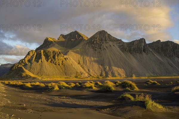 Dune landscape in front of mountain range in the morning light