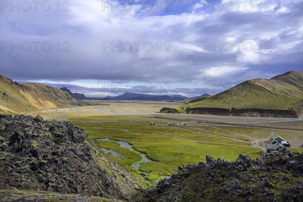 Mountain hut and empty campsite in the foreground Laugahraun lava field