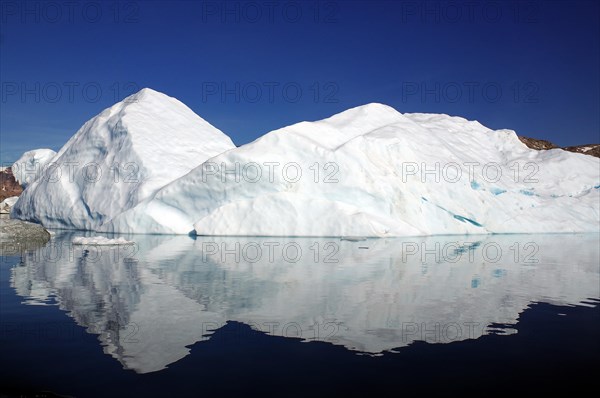 Iceberg reflected in a fjord