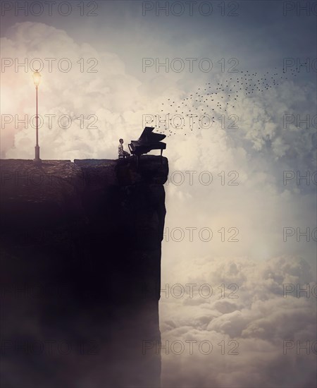 Person silhouette on the edge of a cliff sings and plays a piano song