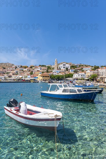 Fishing boats in the harbour of Halki with turquoise water