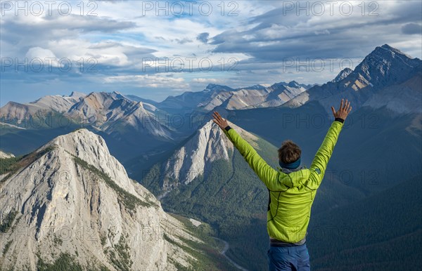 Hiker stretches arms in the air