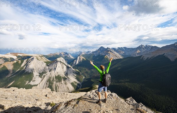 Hiker stretches his arms in the air