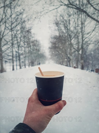 Person hand holding a cup of fresh