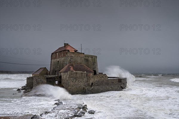 Waves crashing against Vauban's Fort Mahon near Ambleteuse during a winter storm on the North Sea coast