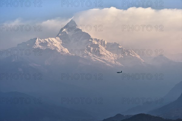 Small plane flies to sacred peak Machhapuchhare Fishtail Mountain