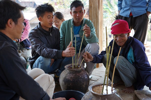 Members of the Khmu people drinking rice wine