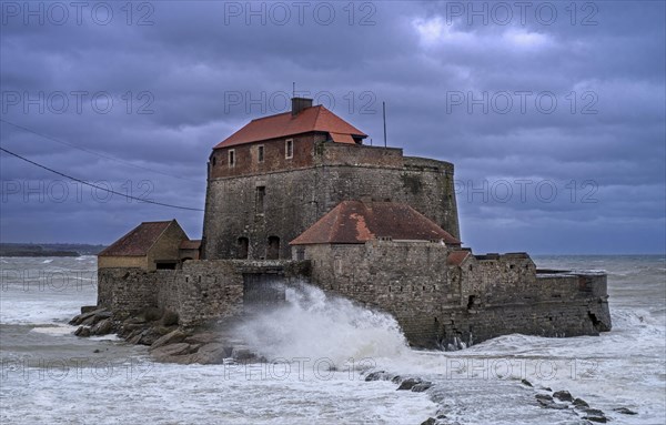 Waves crashing against Vauban's Fort Mahon near Ambleteuse during a winter storm on the North Sea coast