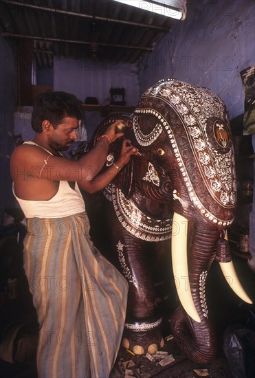 Artisan carving five feet tall rosewood elephant at Mysuru