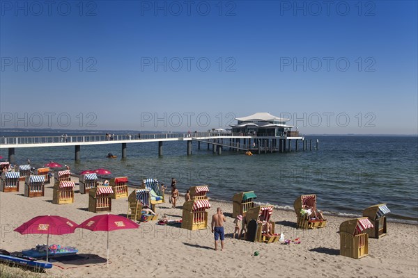 Beach chairs at Timmendorfer Strand with Seeschloesschenbruecke and Japanese teahouse